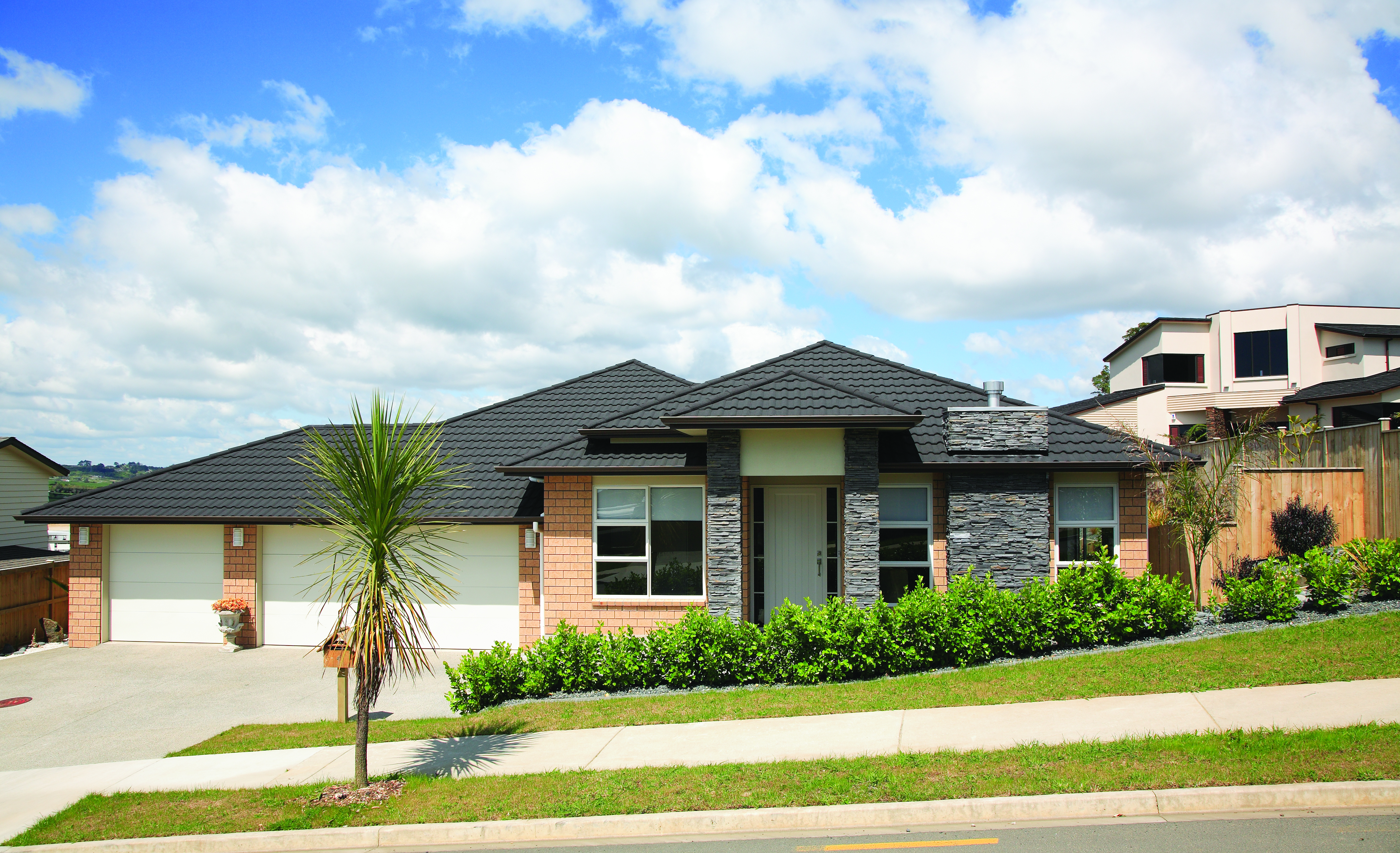 Gerard Milano steel roof on brick house in suburban environment